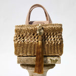 Almeria Sahara Mini Tote Bag showcasing intricate braided metallic leather and tassel detail in luxury design.