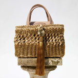 Almeria Sahara Mini Tote Bag showcasing intricate braided metallic leather and tassel detail in luxury design.