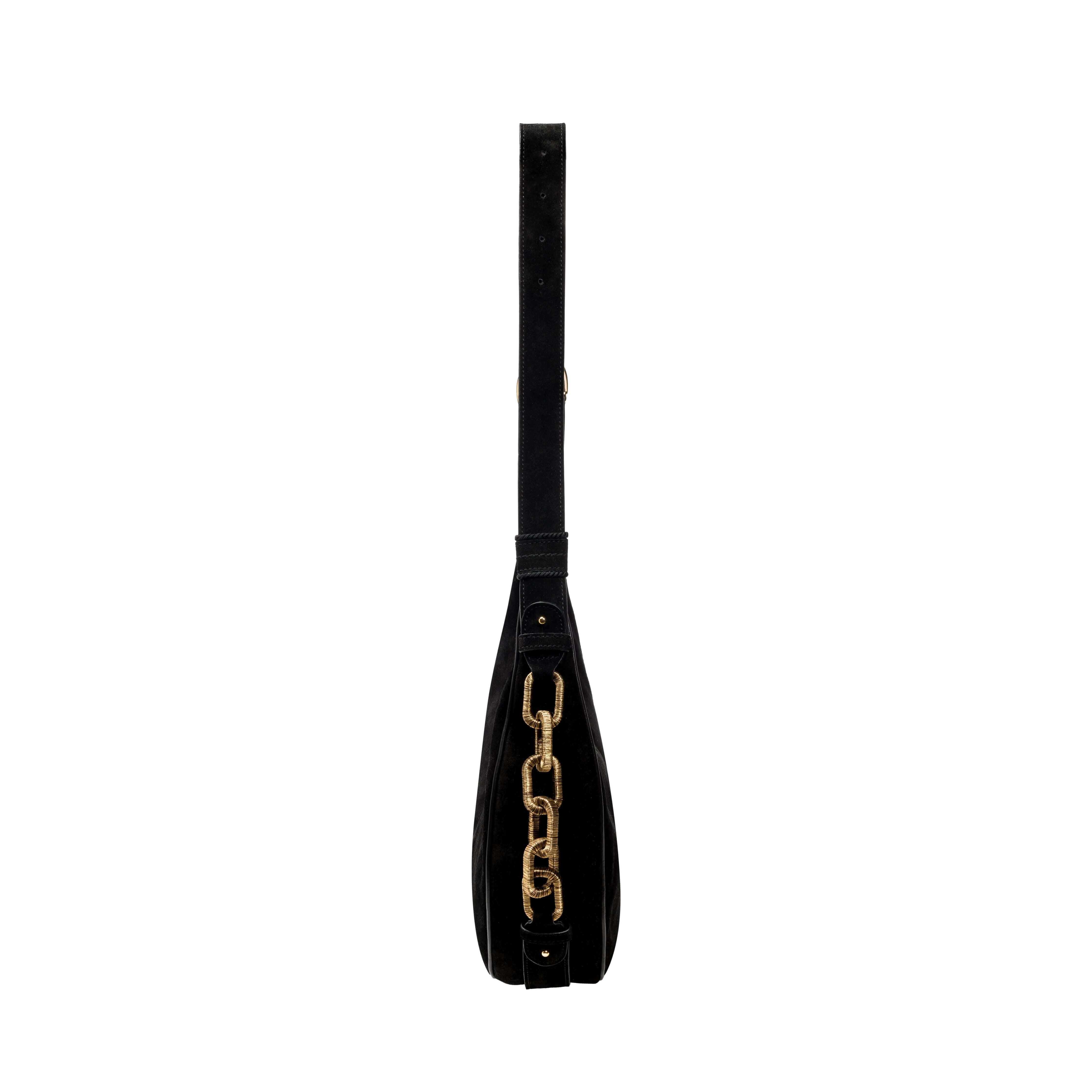 Profile view of the Catena Black Hobo Bag showcasing black suede, adjustable strap, and signature gold chain.