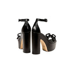 Elegant Catena Black Platform Ankle Sandals featuring chunky block heels and wrapped chain embellishments.