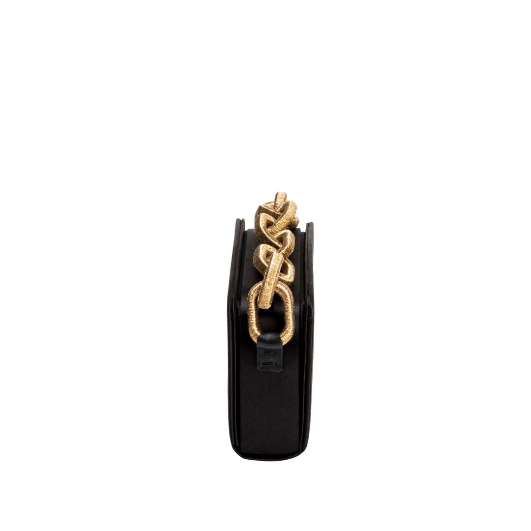 Catena Black Two Sided Bag featuring luxurious silk satin and metallic chain-link handle, showcasing elegant design.