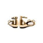 Stylish Catena gold flat ankle sandals featuring a unique chain detail and a comfortable design from the back view.