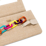 Catena Natural Envelope Clutch with colorful chain embroidery detail against natural linen texture.
