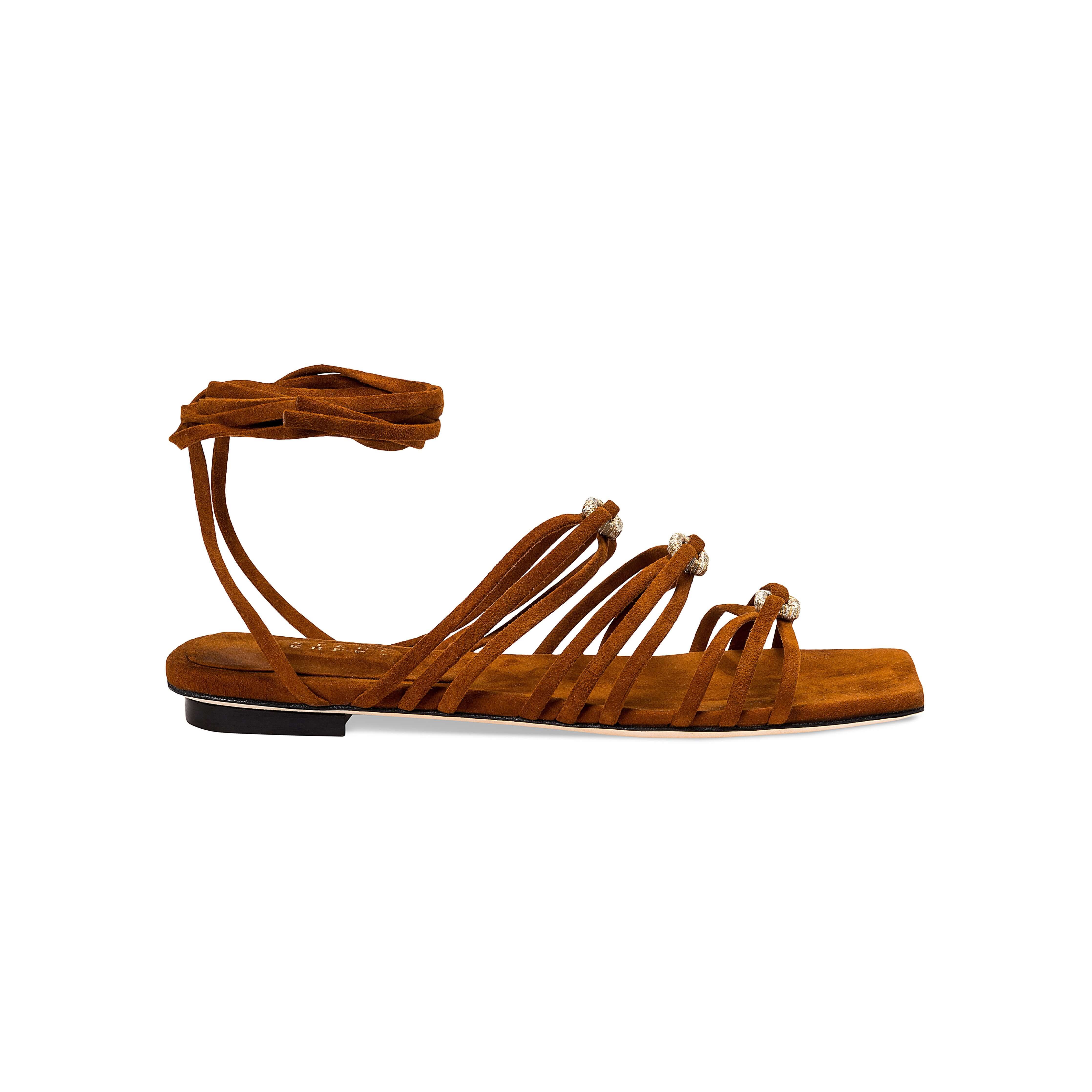 Catena Notte Camello flat lace-up sandals with soft suede straps and gold accents, perfect for summer adventures in style.