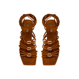 Catena Notte Camello flat lace-up sandal with suede straps and metallic details, perfect for summer adventures.