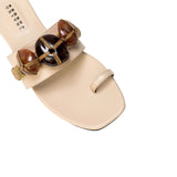 Delphine Nude Flat Toe Sandal with earth-colored beads and wide front strap, perfect for summer styling.