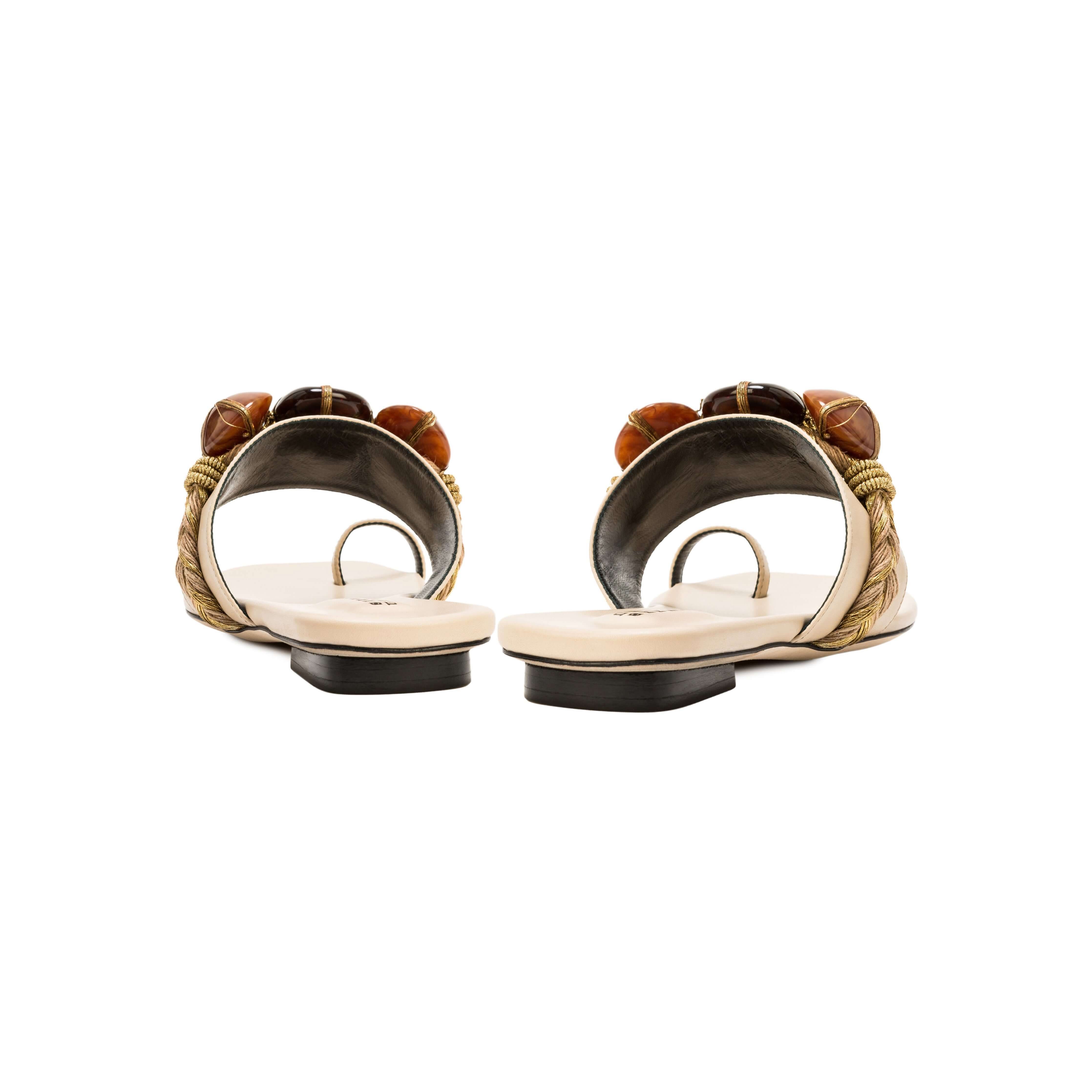 Back view of Delphine Nude Flat Toe Sandal featuring shiny earth-colored beads and a comfortable wide front strap.