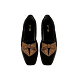 Fiocco black velvet flat moccasin with antique gold embroidered bow, highlighting comfort and chic autumn style.