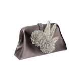 Fiora Electrum Pouch Bag featuring exquisite silver flower embellishments, perfect for elegant evening events.