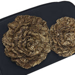 Close-up of gold Florette embellishments on a Lavinia Black Two-Sided Clutch, showcasing elegance and opulence.