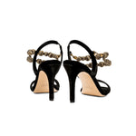 Back view of Lyra Black High-Heel Sandal with slingback straps and gold embellished chains, showcasing luxurious velvet fabric.