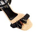 Melita Natural Wedge Ankle Sandal with soft raffia, embroidered stones, and black twisting ropes for island-inspired style.