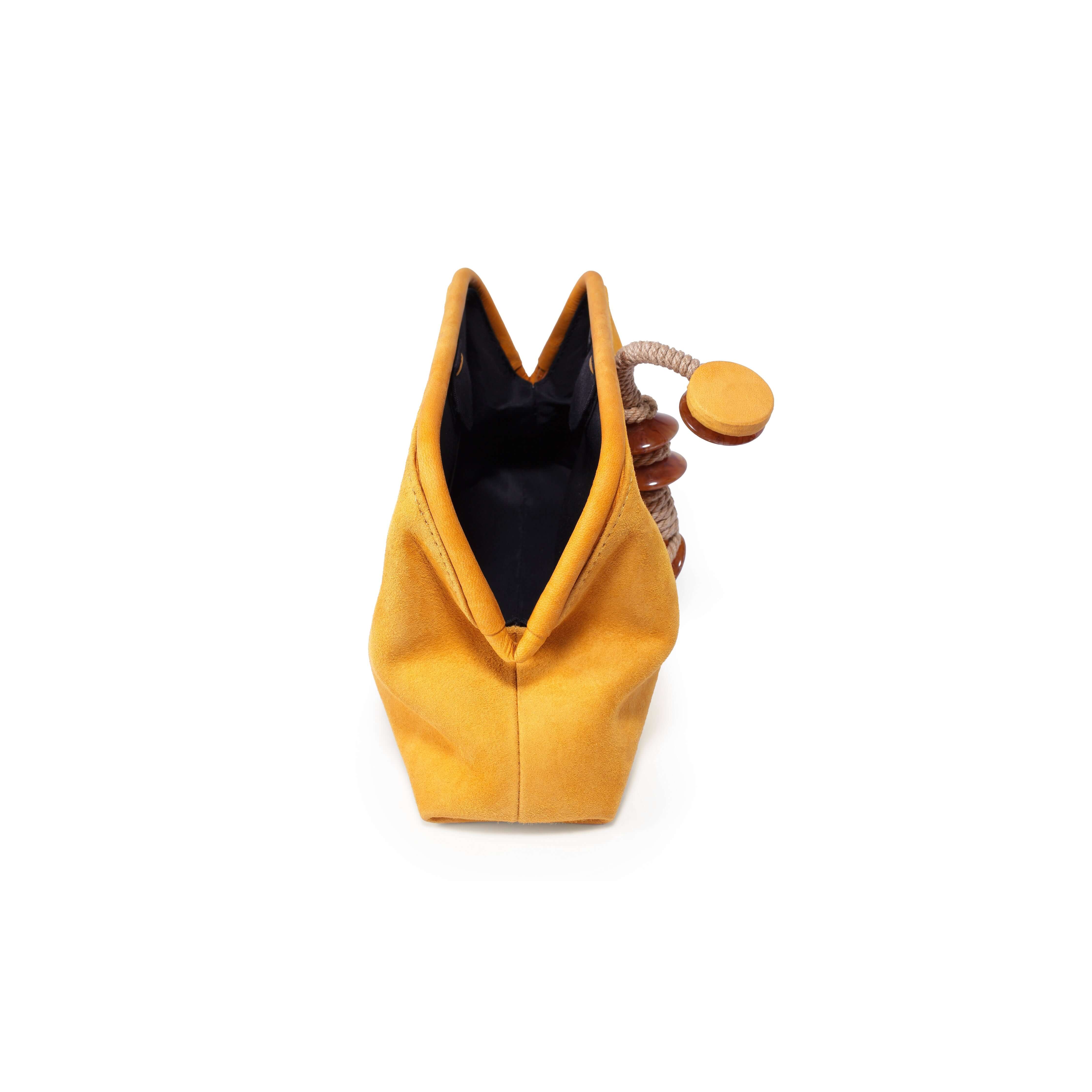 Petra Mustard Pouch Bag featuring a unique design with a drawstring closure and a stylish mustard color.
