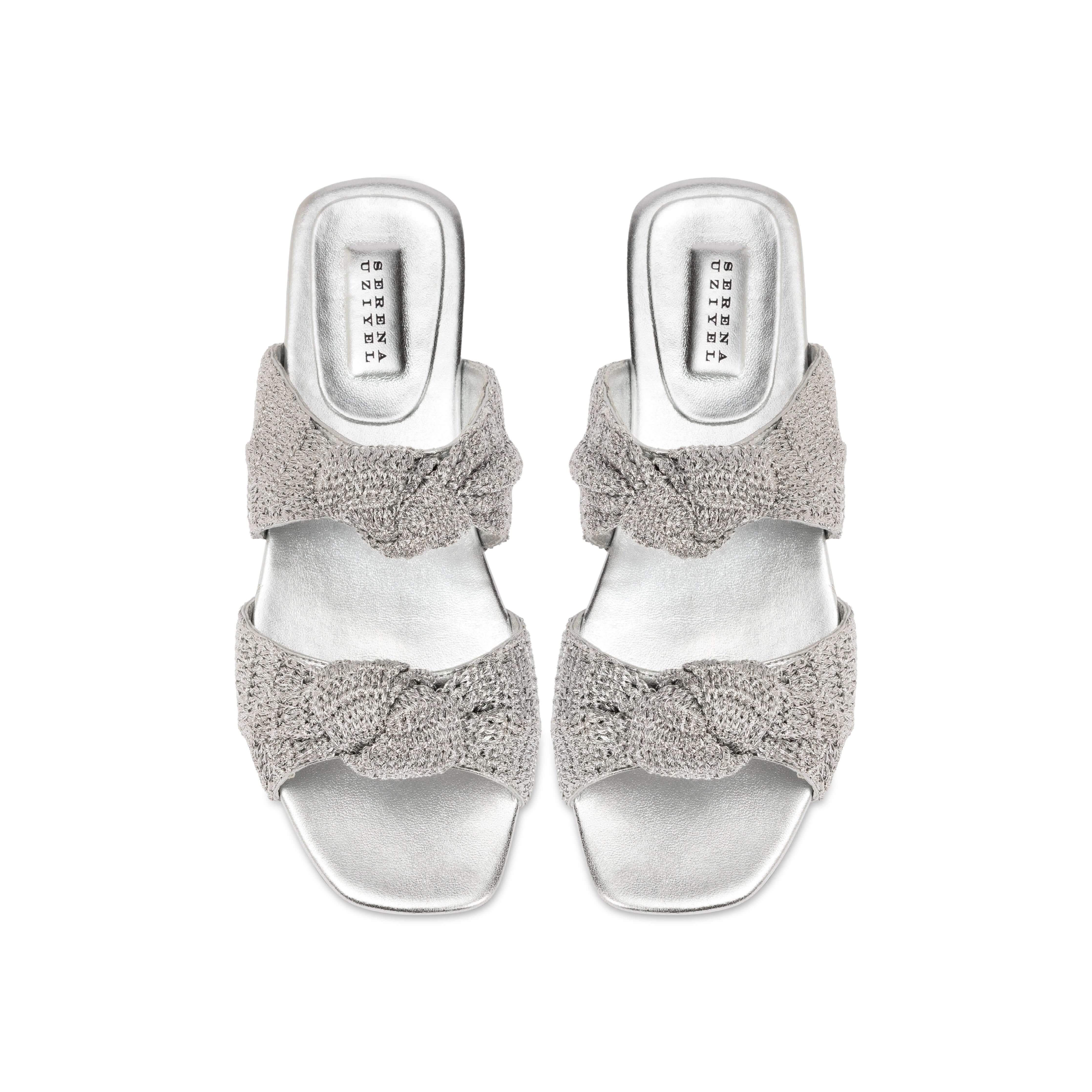 Rhea Silver 2 Knots Sandal featuring two intricately knotted crochet straps and a sleek metallic finish.