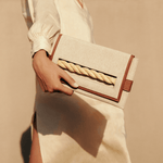 Thory Camello Envelope Clutch in natural canvas with camello leather trim, featuring a twisted raffia closure.