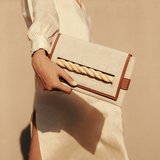 Thory Camello Envelope Clutch in natural canvas with camello leather trim, featuring a twisted raffia closure.