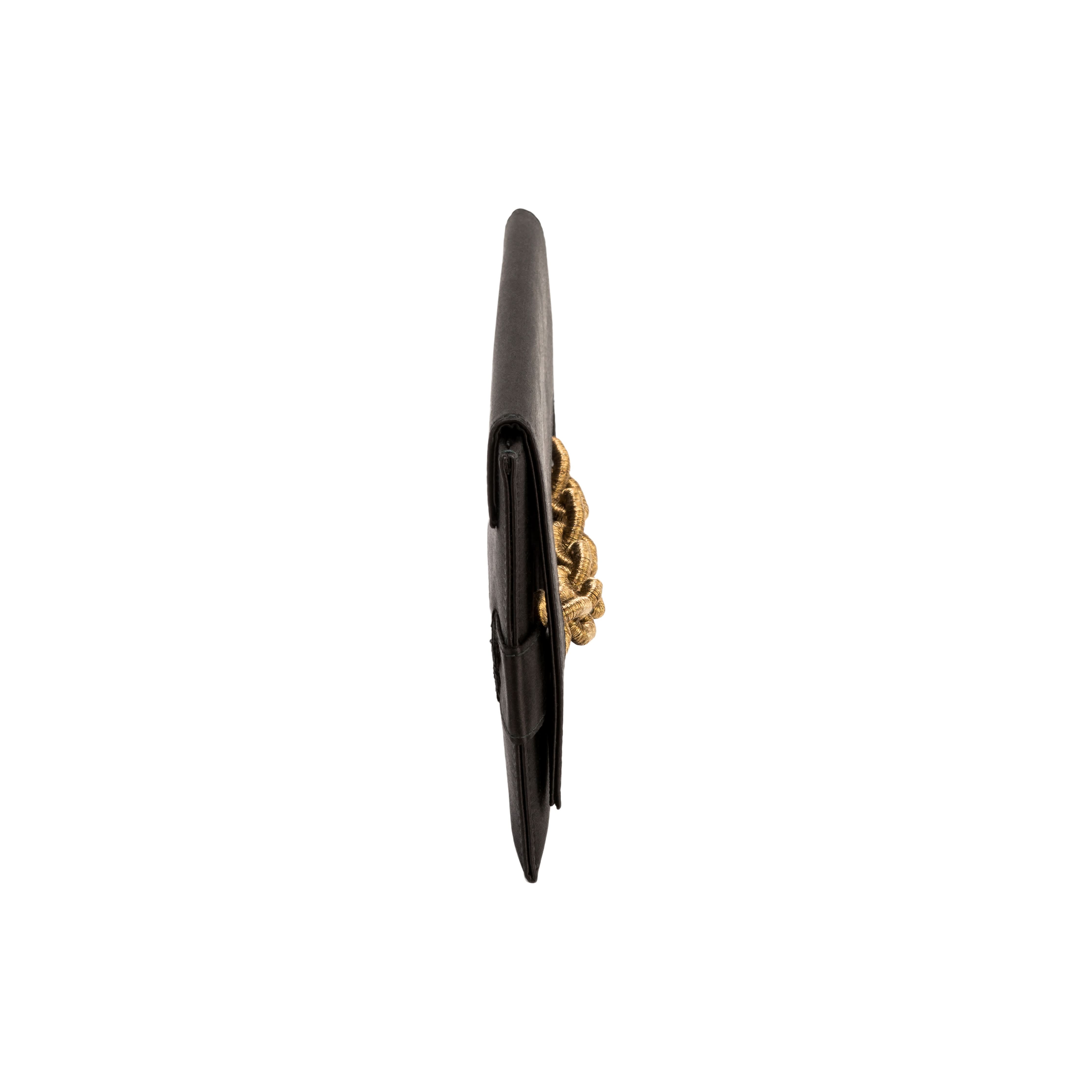 Side view of the Catena Black Envelope Clutch, showcasing its sleek design and intricate gold chain embroidery.