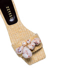 Taurea Natural Flat Sandal in sand raffia with natural stone embellishments, showcasing a comfortable square toe design.