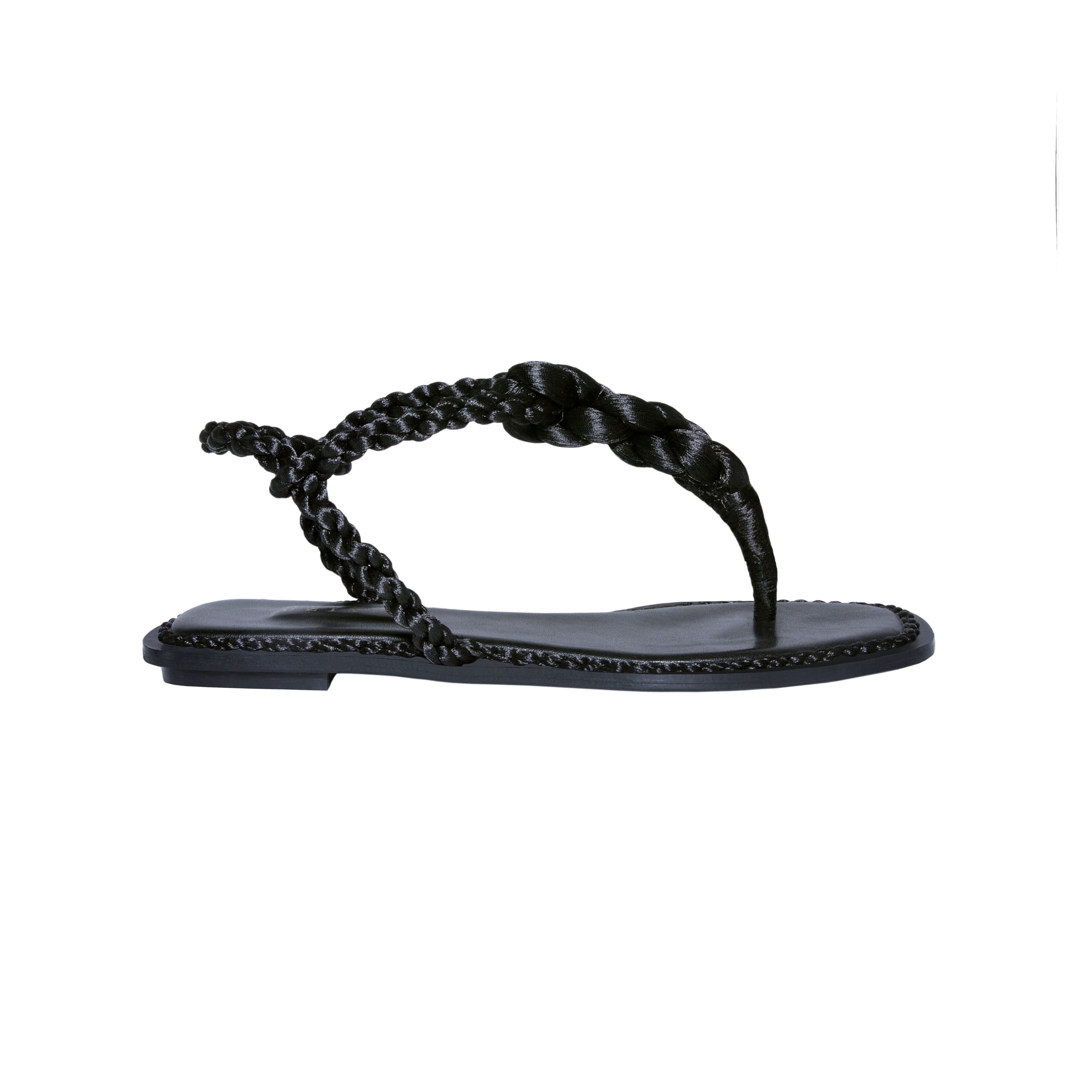 Thory Black Flat Sandal featuring braided metallic thread straps and an elegant Italian leather sole.